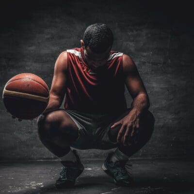player kneeling with a basketball